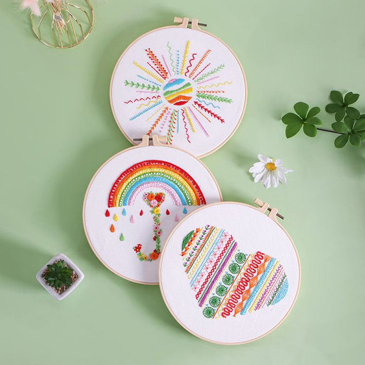 Simple embroidery kits for beginners with heart, rainbow, and sun designs on adjustable hoops.